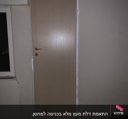 דלת עץ חומה עם ידית מתכת על קיר חיצוני